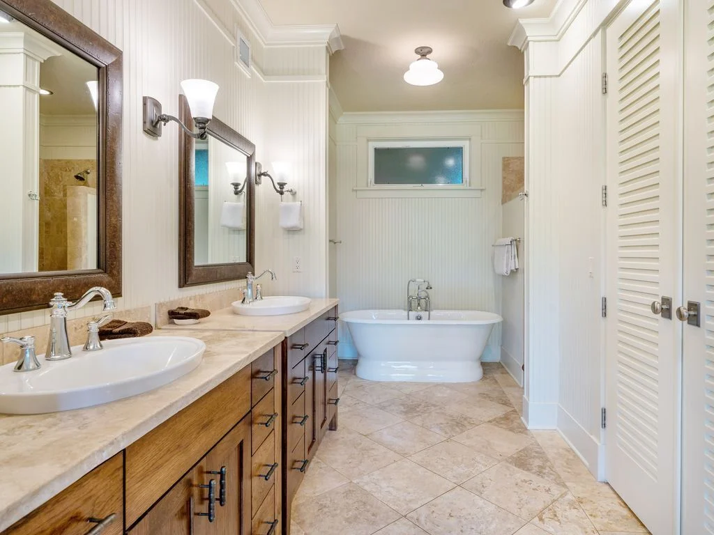 Two sinks, vanities, and a huge tub in bathroom